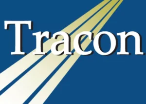 Logo Tracon berwarna biru dengan garis-garis kuning dan putih di latar belakang